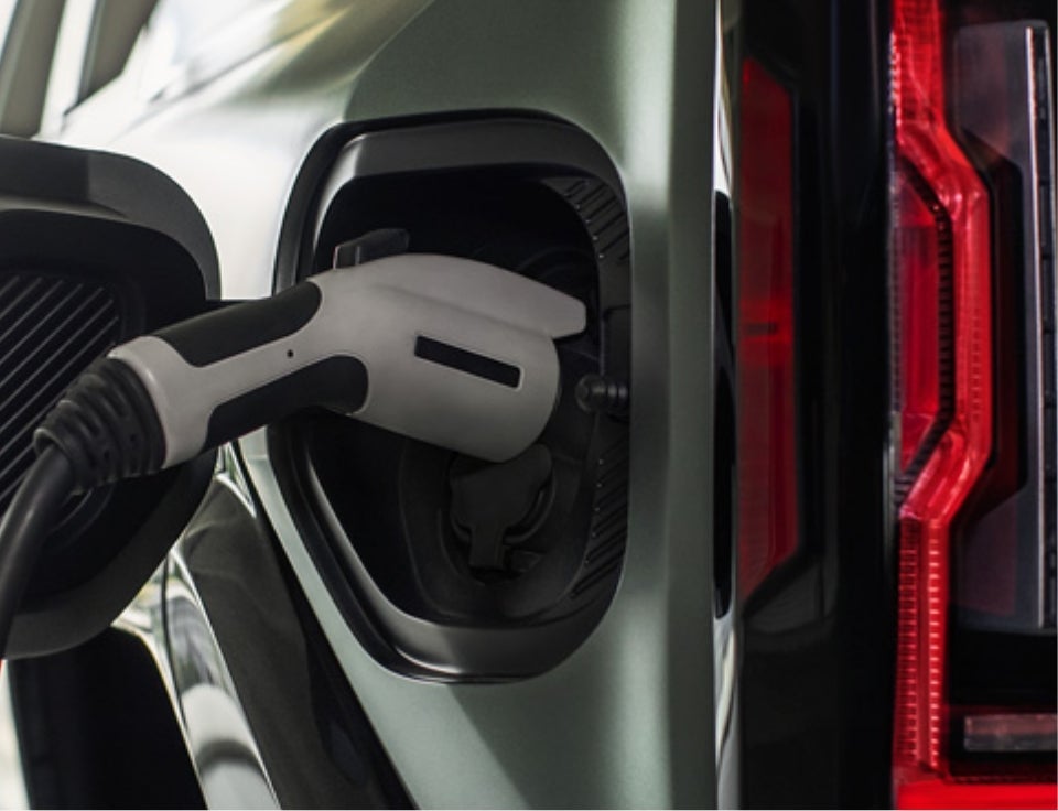 Close up of charging port with charger plugged in on a GMC Hummer EV SUV - Hart Motors GMC in Salem VA